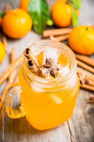 Icy cold mandarin beverage on the rustic background. Selective focus. Shallow depth of field. photo