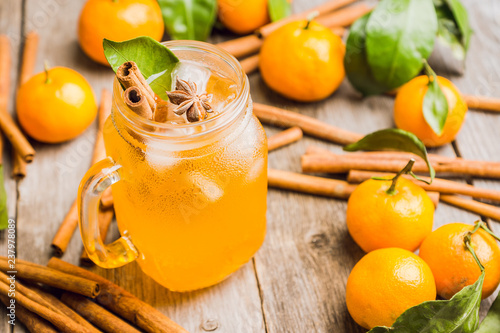 Icy cold mandarin beverage on the rustic background. Selective focus. Shallow depth of field. photo