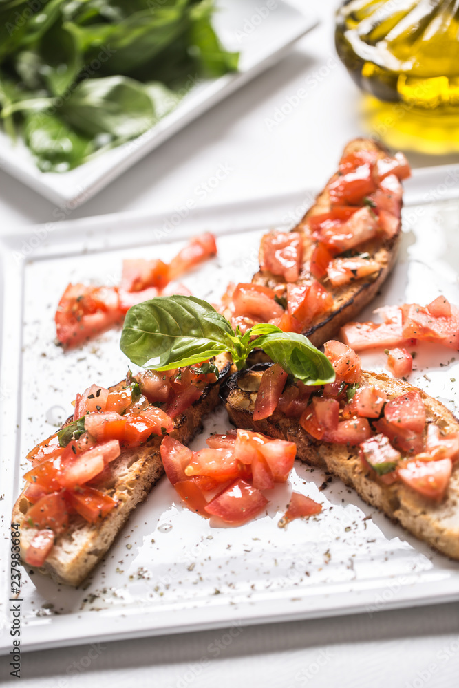 Tasty italian appetizer bruschetta on plate with olive oil Tasty italian appetizer bruschetta on plate with olive oil
