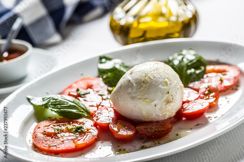 Caprese salad from mozzarella tomatoes basil olive oil an spices