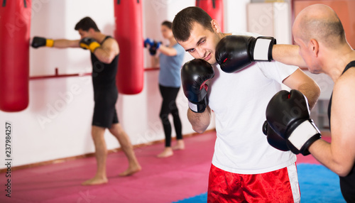 Adult sportsmen competing in boxing gloves
