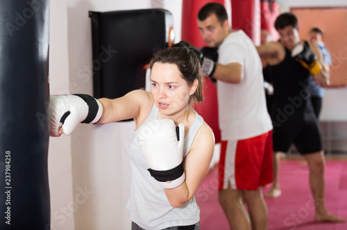  woman beating boxing bag
