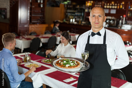 Waiter with tray in restaurant © JackF
