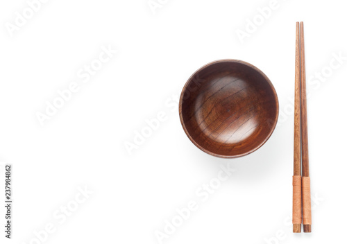 Wooden bowl with chopsticks isolated on white background. Top view.