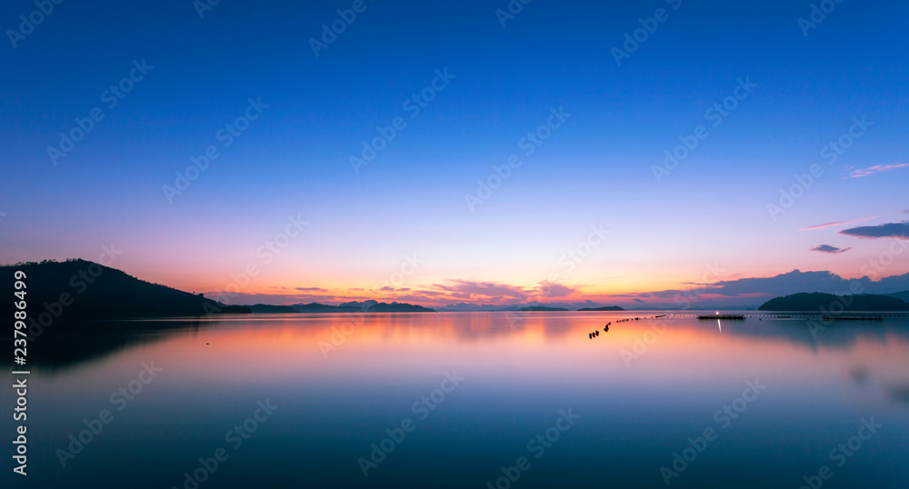 Colorful dramatic sky and seascape with reflection in the sea scenery of nature in evening sunset time