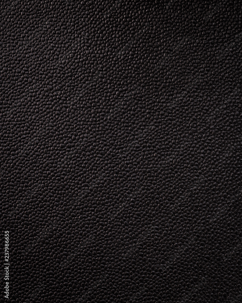 Vertical black leather texture. Synthetic material background in rough style. Vertical black leather texture. Synthetic material background in rough style.