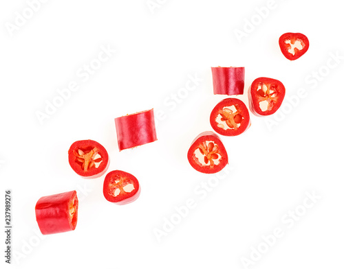 Photos Red chopped chili peppers on white background. Top view.