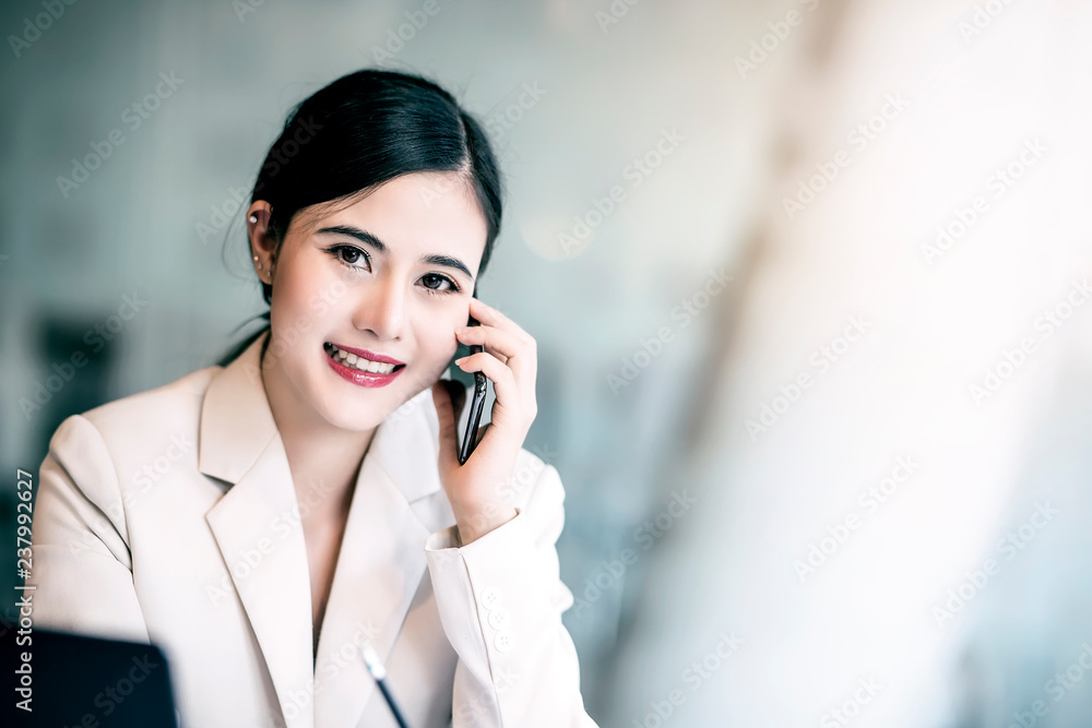 Portrait of young beautiful businesswoman using smartphone at modern office. Portrait of young beautiful businesswoman using smartphone at modern office.