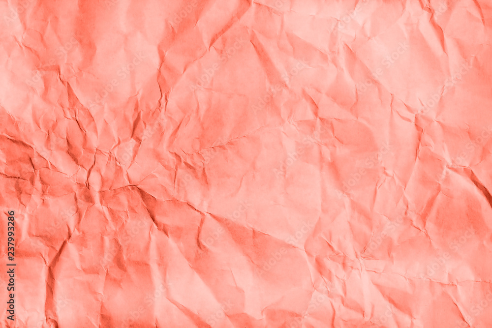 Fototapeta premium Living Coral Crumpled paper texture. Flat lay, top view