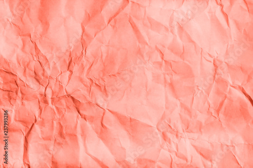 Living Coral Crumpled paper texture. Flat lay, top view