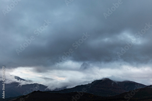 Cloudy landscape on the top of a mountain silhouette © jordieasy