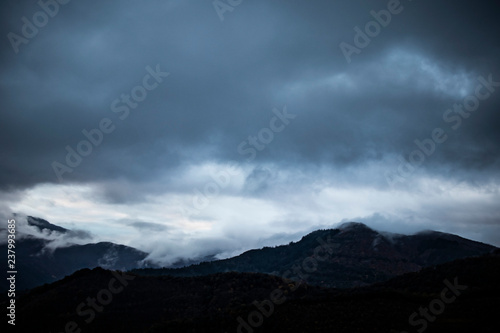Cloudy landscape on the top of a mountain silhouette