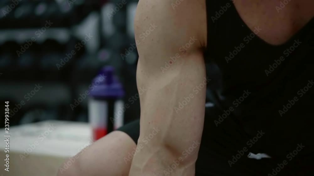 male bodybuilder performs a bicep exercise approach and then drinks the amino acid complex from the shaker to quickly restore the destroyed muscles male bodybuilder performs a bicep exercise approach and then drinks the amino acid complex from the shaker to quickly restore the destroyed muscles