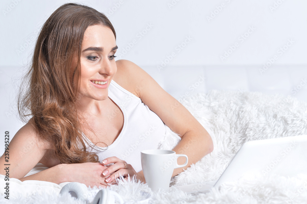 Portrait of young brunette woman relaxing in bed Portrait of young brunette woman relaxing in bed