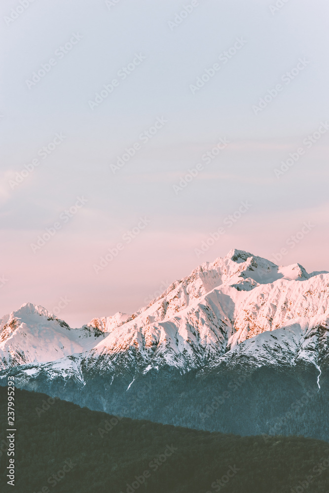 Obraz premium Snowy mountains peaks range landscape travel aerial view wilderness nature tranquil evening winter sunset scenery
