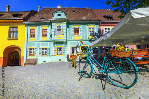 Vászonkép Fantastic medieval street cafe bar with traditional buildings, Sighisoara, Roman