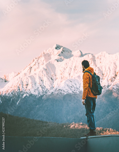 Man adventurer alone enjoying sunset mountains view active lifestyle winter vacations outdoor hiking adventure solo trip