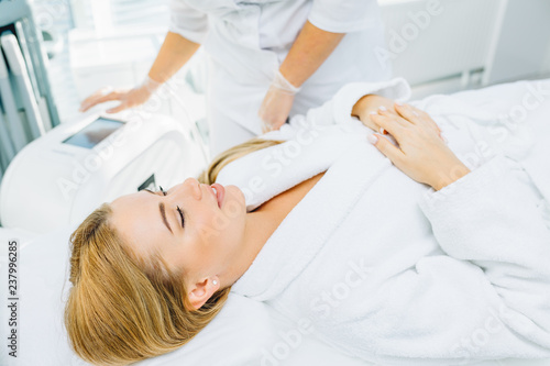 Gorgeous woman in beauty clinic receiving non-surgical face lifting. SMAS lifting ultrasonic. Facelift. The process of rejuvenation. Spa treatment. Hardware cosmetology.