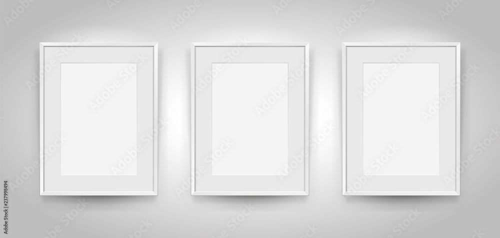 Three realistic empty rectangular white frames with passepartout on gray background, border for your creative project, mock-up sample, picture on the wall, vector design object Three realistic empty rectangular white frames with passepartout on gray background, border for your creative project, mock-up sample, picture on the wall, vector design object
