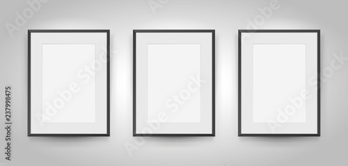 Three realistic empty rectangular black frames with passepartout on gray background, border for your creative project, mock-up sample, picture on the wall, vector design object