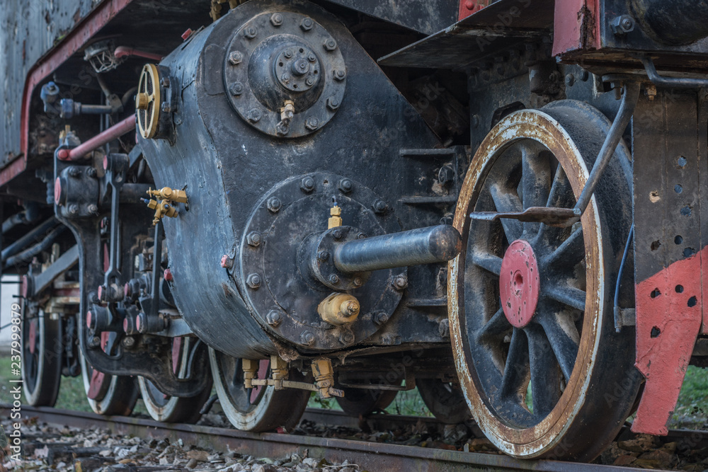 Old black steam locomotive train with close-up wheels and parts