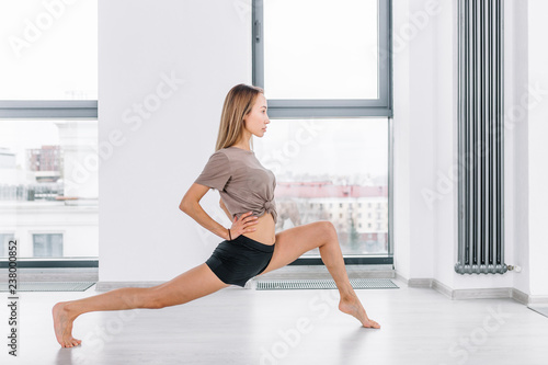 young athlete girl streatching befor workout. full length side view photo. healthcare