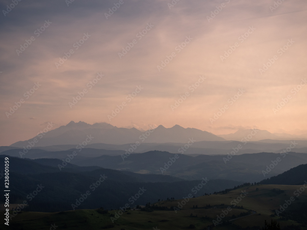 Pieniny Mountains in summer at sunset. View from Wysoki Wierch toward High Tatras.