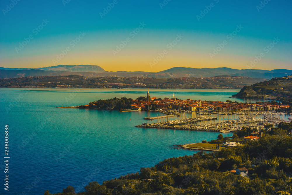 Aerial view of old fishing town Izola. Colorful spring evening on Adriatic Sea. Beautiful seascape of Slovenia, Europe. Beauty of countryside concept background. Artistic style post processed photo.
