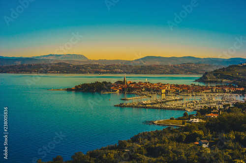 Fototapeta Naklejka Na Ścianę i Meble -  Aerial view of old fishing town Izola. Colorful spring evening on Adriatic Sea. Beautiful seascape of Slovenia, Europe. Beauty of countryside concept background. Artistic style post processed photo.