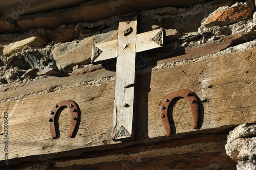 Popular superstition, house protected with a crucifix and two horseshoes in Las Hurdes, mountainous region of the north of the province of Cáceres in Extremadura, Spain. photo