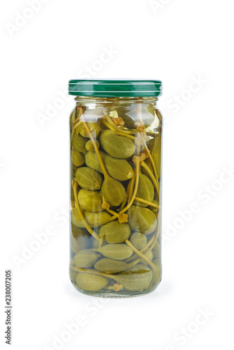 Glass jar with capers berries on a white background