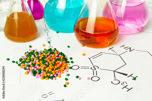 Plastic raw material in granules against the background of Chemical Laboratory and reagents. Polypropylene, Ethylene, Polypropylene research in laboratory conditions