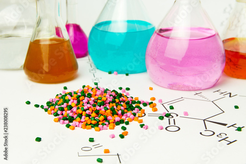 Plastic raw material in granules against the background of Chemical Laboratory and reagents. Polypropylene, Ethylene, Polypropylene research in laboratory conditions photo