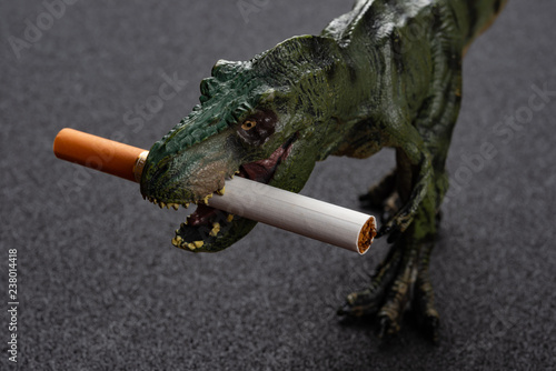 tyrannosaurus with a cigarette on the mouth concept of unhealthy smoking
