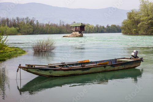 Lonely house and small boat on the river Drina, Serbia photo