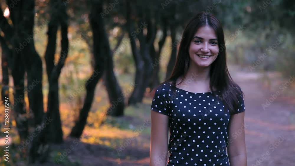 young cute girl looking at camera in the park at sunset young cute girl looking at camera in the park at sunset