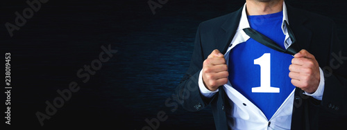 Foto Man tearing shirt and showing number 1. Winner