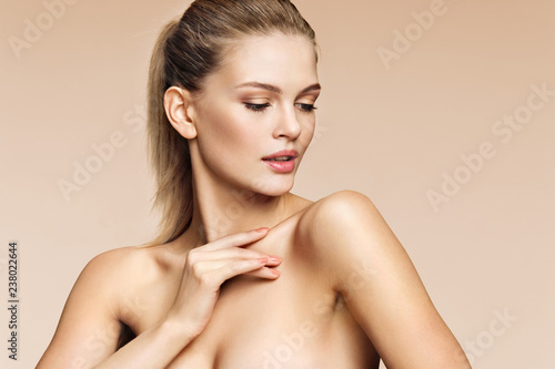Young pretty girl with professional makeup on beige background. Beauty