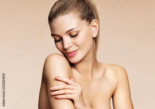 Sensual blonde woman with beautiful make up on beige background. Youth and Skin care concept