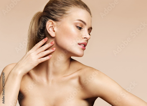 Image with beautiful girl touching her face on beige background. Beauty & Skin care concept