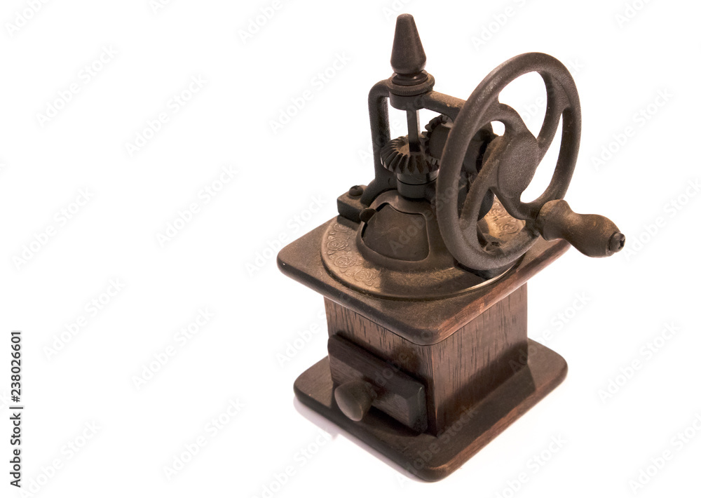 Old manual wooden coffee grinder with gear wheel isolated on white background Old manual wooden coffee grinder with gear wheel isolated on white background