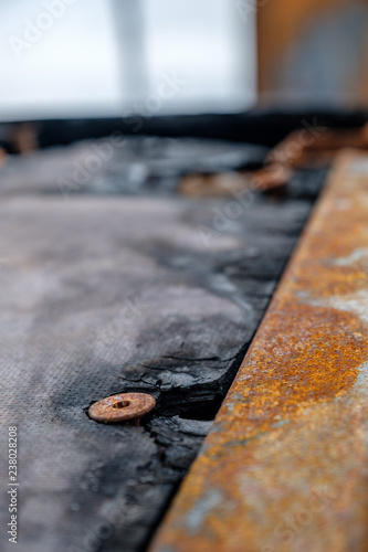 close-up on the head of a rusty screw in a train carriage