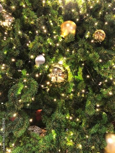 christmas tree in close-up look, full of decorations and lights, giving the atmosphere of magical christmas in december.
