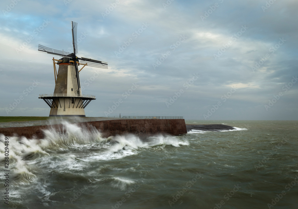 This beautiful windmill is located in Vlissingen straight at the North sea, that day there was a lot of wind making big waves crash to the dike.