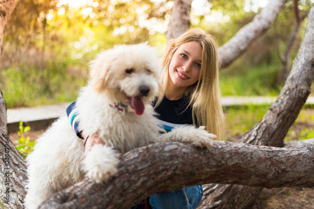 Young girl with her dog in a park Young girl with her dog in a park