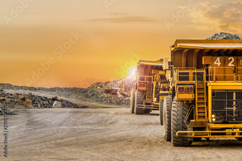 Mining dump trucks transporting Platinum ore for processing photo