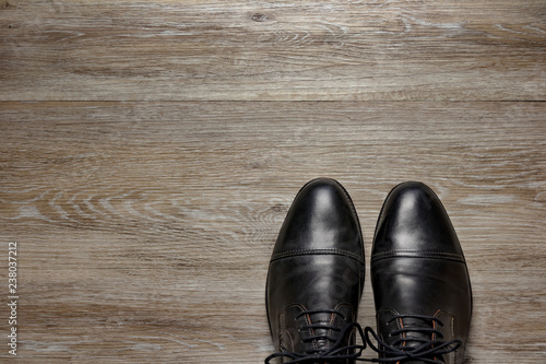 top view of a pair of men's shoes on a wooden floor