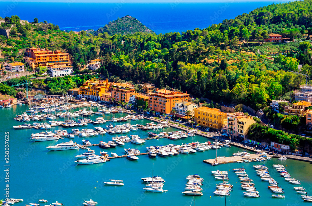 Porto Ercole town,  Monte Argentario, in the Province of Grosseto, Tuscany, Italy. Boats in harbor in a sea bay.