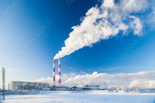 Smoke of factory pipes pollutes atmosphere of the city. Concept of oil, coal, gas processing, pollution of environment, emissions into water resources, oncological diseases, cancer