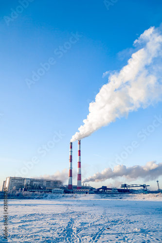 Smoke of factory pipes pollutes atmosphere of the city. Concept of oil, coal, gas processing, pollution of environment, emissions into water resources, oncological diseases, cancer